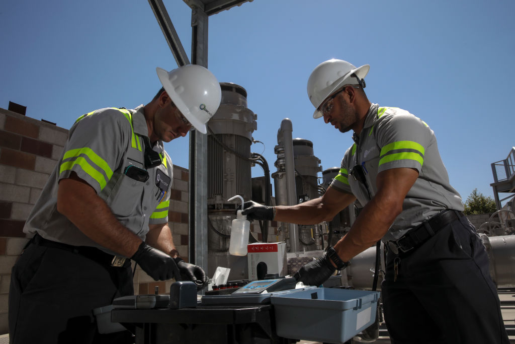 Pico Rivera, CA - June 28: Trenton Guinta, left, and Bert Mantilla Jr., work at influent pumping station at Water Replacement Districts (WRD) advanced water treatment facility at Albert Robles Center on Tuesday, June 28, 2022 in Pico Rivera, CA. (Irfan Khan / Los Angeles Times via Getty Images)